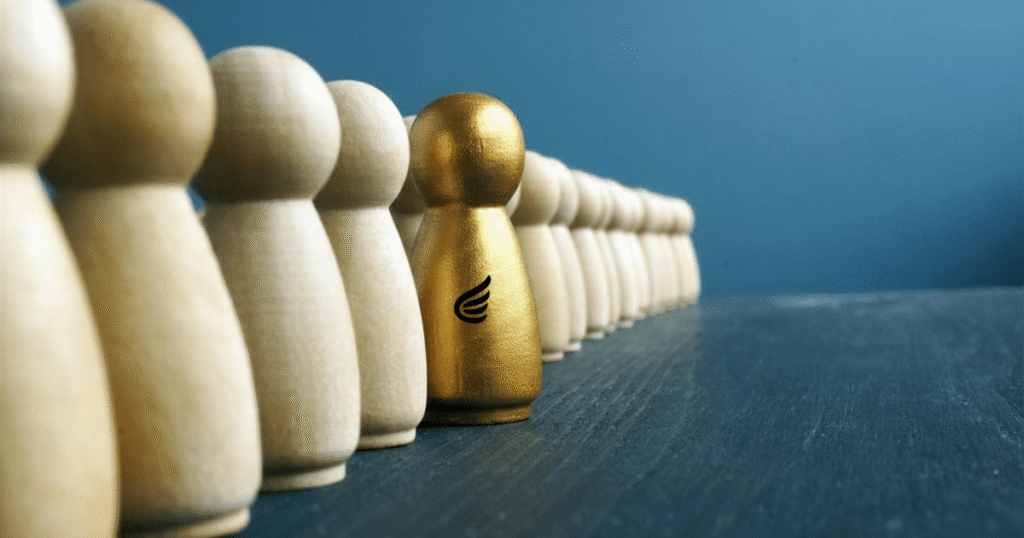 A gold leadership figure standing among a team, symbolizing Double U Advisors’ approach to developing exceptional fractional leaders who strengthen businesses from within.